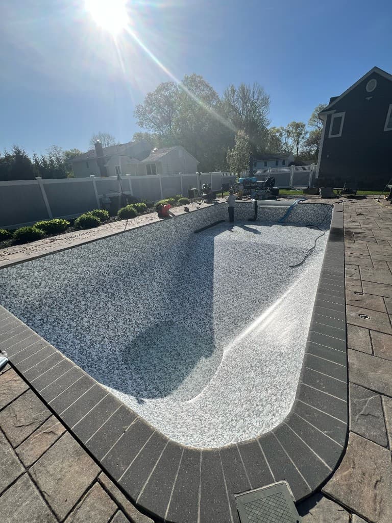 After: liner sealed at walls and coping, shell photographed before balance and refill.