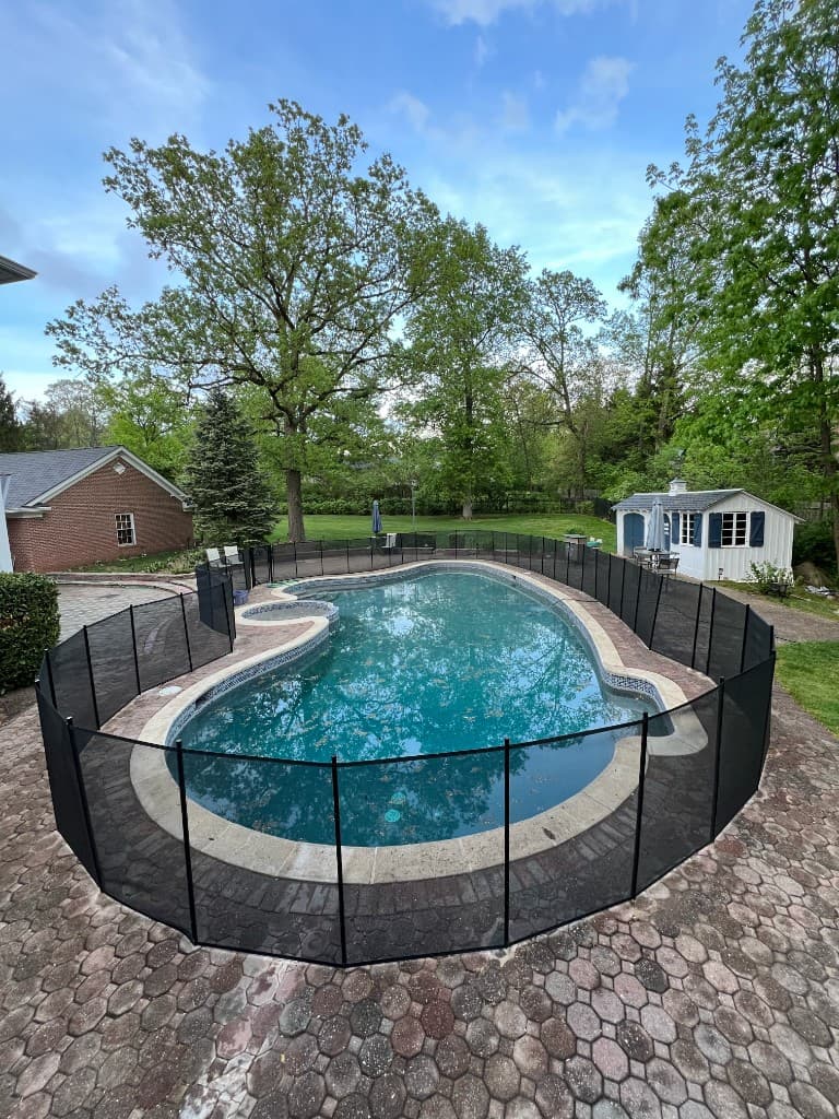 Rectangular pool with poured coping and wide concrete decking, finished hardscape so skimmers, ports, and pump access stay reachable for service.